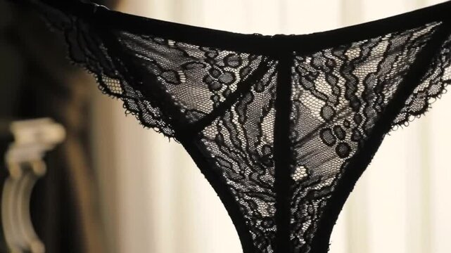 Elegant close-up of black lace lingerie in a high-end setting, showcasing sophistication and detail