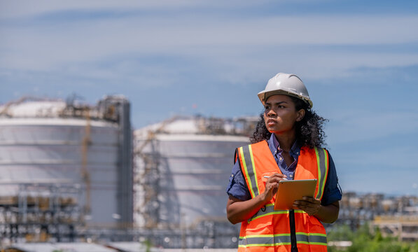 Engineer industrial facility petrochemical or gas energy site focused balance between industrial development and environmental preservation impact while maintaining efficiency and safety standards. - Powered by Adobe