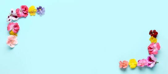 Frame made of beautiful flowers on blue background