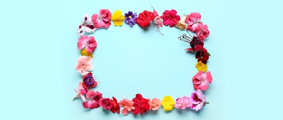 Frame made of beautiful flowers on blue background