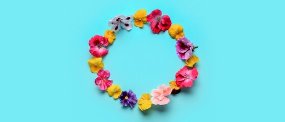Frame made of beautiful flowers on blue background