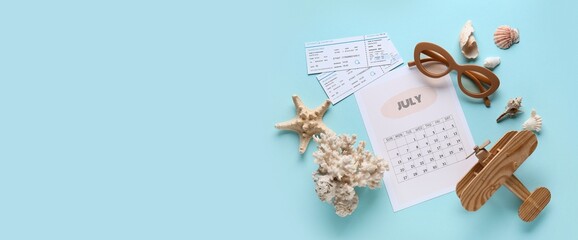 Calendar with sunglasses, tickets and wooden airplane on blue background with space for text