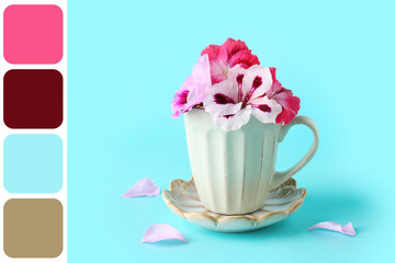 Cup with different beautiful edible flowers and petals on blue background