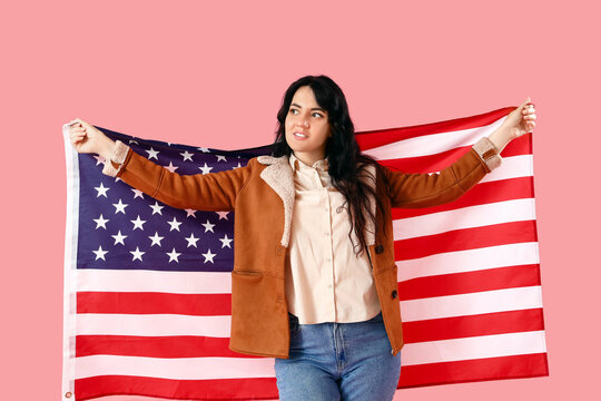 Beautiful young woman with USA flag on pink background - Powered by Adobe