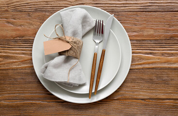 Stylish modern table setting on brown wooden background