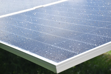 Close-up of solar panel surface with water droplets after rain, clean energy technology and...
