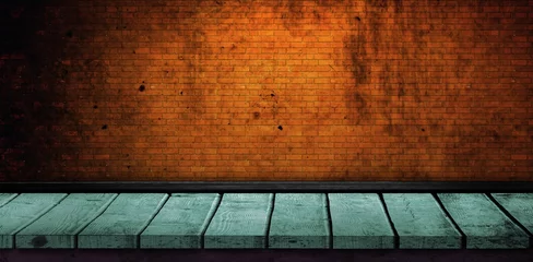 Green floorboard by brick wall