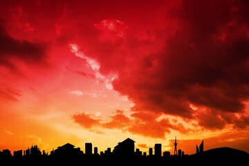 City skyline is glowing against fiery red sunset in flat design with skyscraper and tower outlines