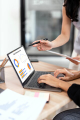 Businesswoman advisor, two business people talking, planning analyze investment and marketing on laptop in office.