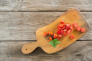 Red tomatoes on wooden cutting board