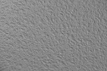 Flat design rough grey concrete texture is filling frame with irregular bumps and depressions
