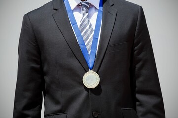 Midsection of businessman wearing medal