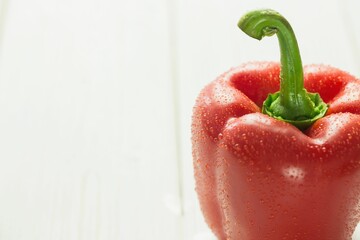 Fresh red pepper on wooden table
