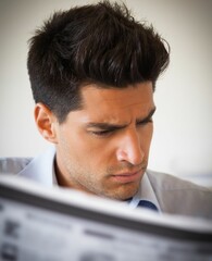 Casual businessman reading newspaper