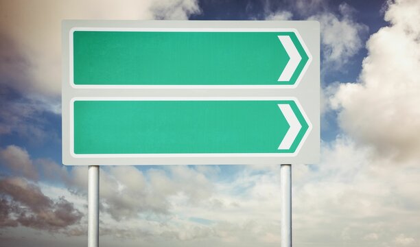 Fototapeta Green blank sign post against cloudy sky
