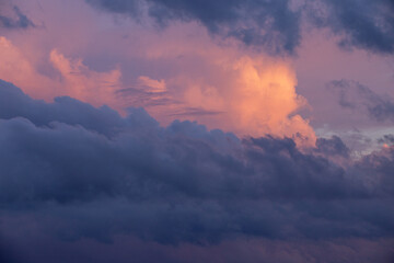 Stormy sky at sunset, bulky clouds on the horizon