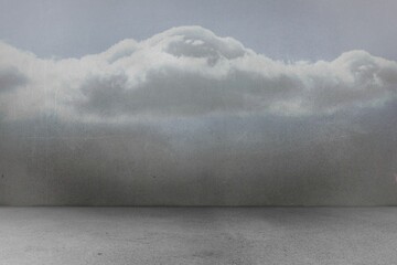 Calm water is meeting muted grey sky in minimalist seascape, featuring billowing cumulus cloud
