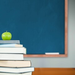 Green apple on pile of books in classroom