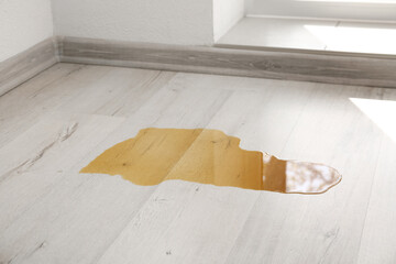 Wooden laminate floor with spilled coffee