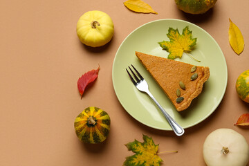 Autumn composition with tasty pumpkin pie on brown background