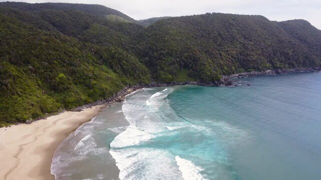 Scenic aerial footage of Rada Ranu beach and the Pacific Ocean meeting untouched coastal forest in southern Chile &ndash; wild beauty from above