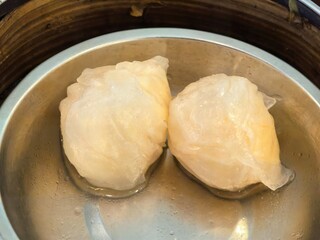 Steamed shrimp dumplings (Har Gow) in a bamboo steamer