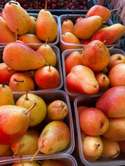 Close-up of ripe pears packaged in plastic containers.