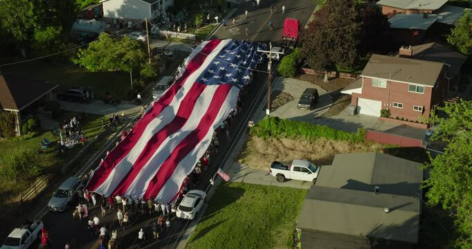 American flag parade on neighborhood street - epic drone shot