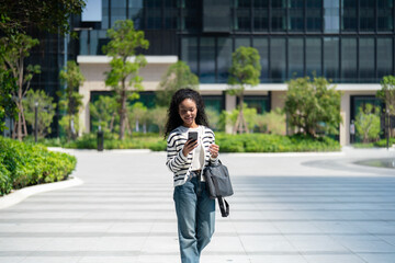 Business casual woman looking at phone outdoors
