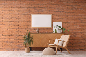 Interior of living room with armchair, commode and blank frame