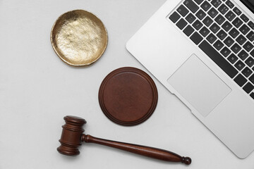 Antique plate with auction gavel and laptop on white grunge background