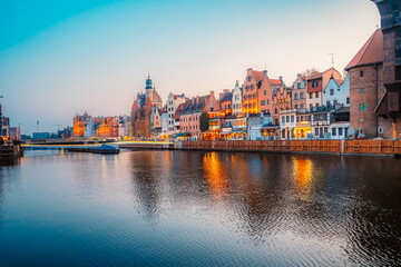 Fototapeta premium Gdansk with Motlawa river in Poland. Old town colourful house with Zuraw or crane and with Holy Spirit Gate
