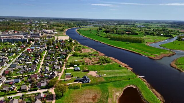 Scenic Aerial View of Joni&scaron;kis With Riverfront Homes and Verdant Countryside