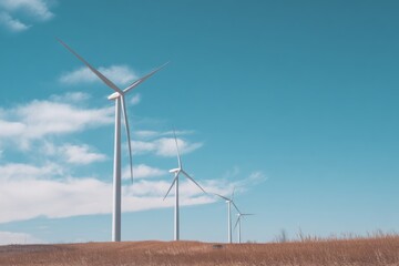 Wind turbines in open field under clear blue sky