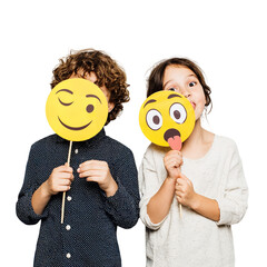 Children with emoji masks having fun and expressing emotions in a playful and creative way on transparent background