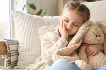 Little girl feeling tooth ache at home