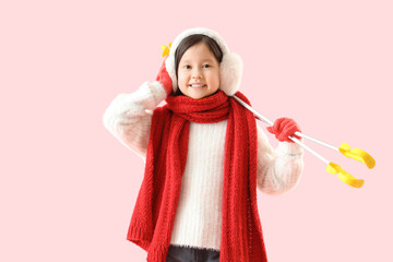 Little Asian skier on pink background