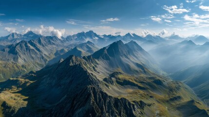 Fototapeta premium Majestic mountain range at sunrise with expansive valleys and cloudy sky