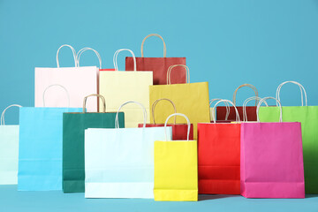 Many colorful shopping bags on blue background