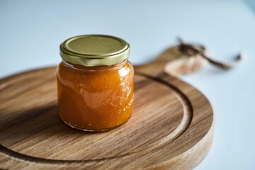 orange jam in a glass jar.