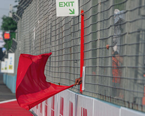 Marshals raise the red flag during a racing championship