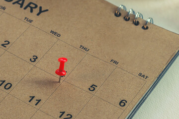 Embroidered pins on a calendar appointment	