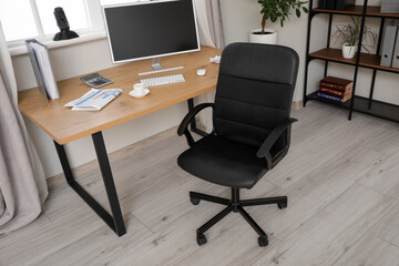 Interior of office with desk and black chair