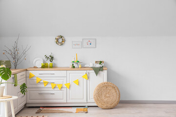 Interior of kitchen decorated for Easter with white counters