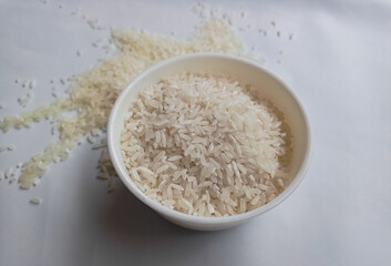 close up bowl of jasmine rice grain isolated on white background