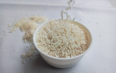 close up bowl of jasmine rice grain isolated on white background