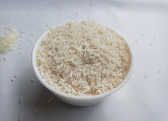 close up bowl of jasmine rice grain isolated on white background