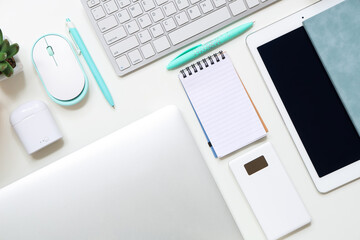 Different gadgets with notebooks on white background