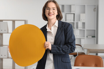 Young businesswoman with bitcoin in office