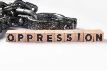 Cubes with word OPPRESSION and handcuffs on white background